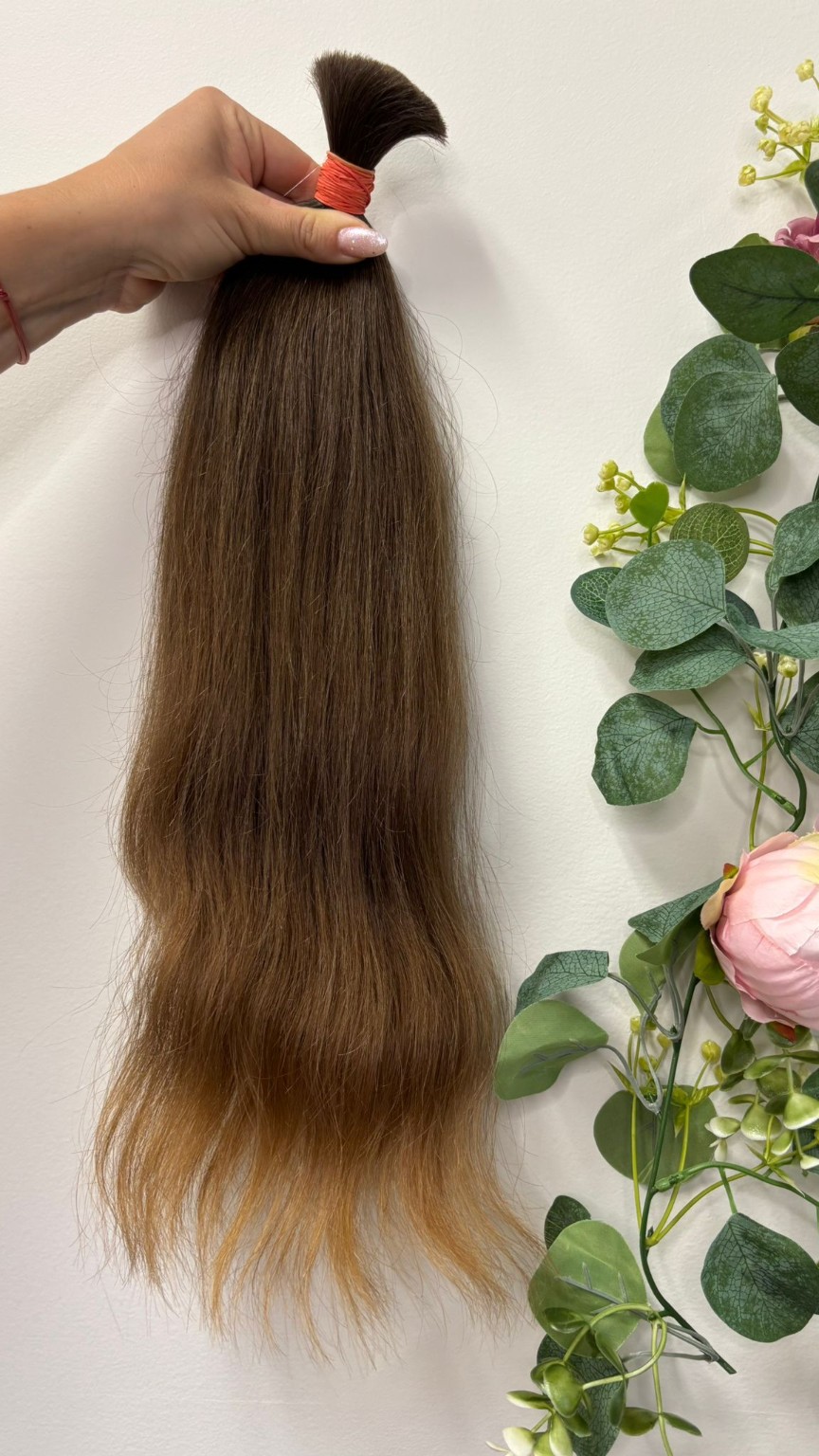 Long straight brunette extension hair selected for custom preparation