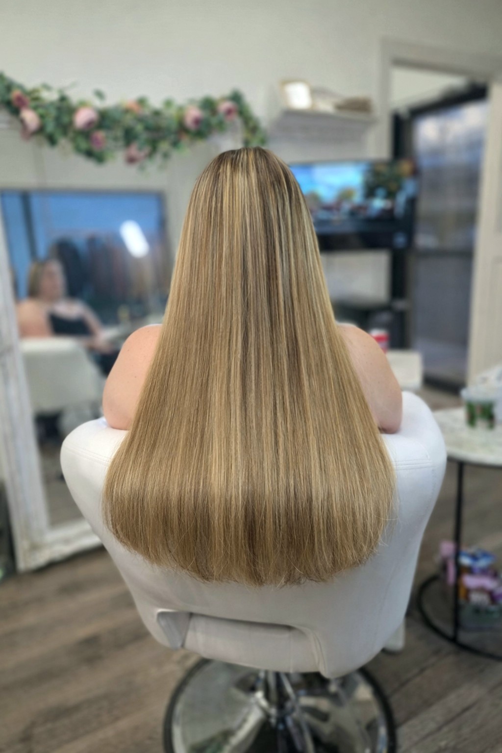 Long warm blonde hair extension result with a seamless natural blend